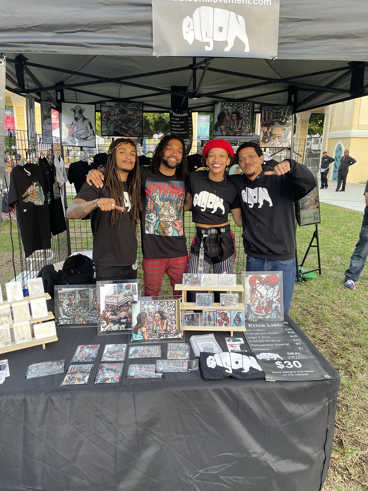 The Bison Movement festival booth with family, vegan art, and merch