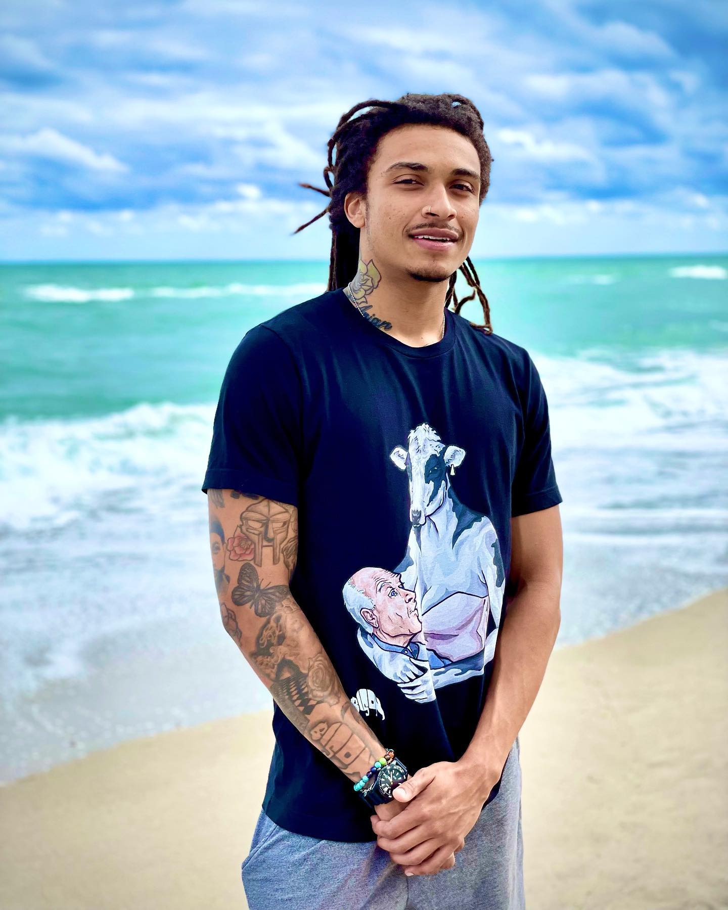 FREE BISON wearing vegan art shirt near the ocean